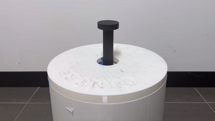 The prototype's black pneumatic ram standing up out of its white CENTRE BOUNCE lid.